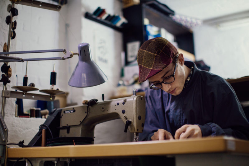 The capmaker Silas Gärtner at his sewing machine