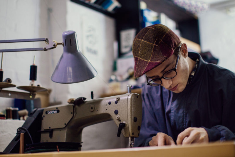 The capmaker Silas Gärtner at his sewing machine