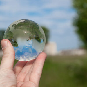Hand holding glass globe