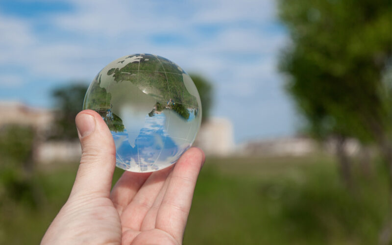 Hand holding glass globe