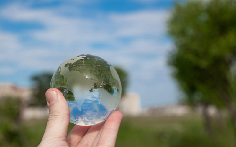 Hand holding glass globe