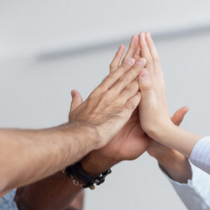 Hands cheering on light background