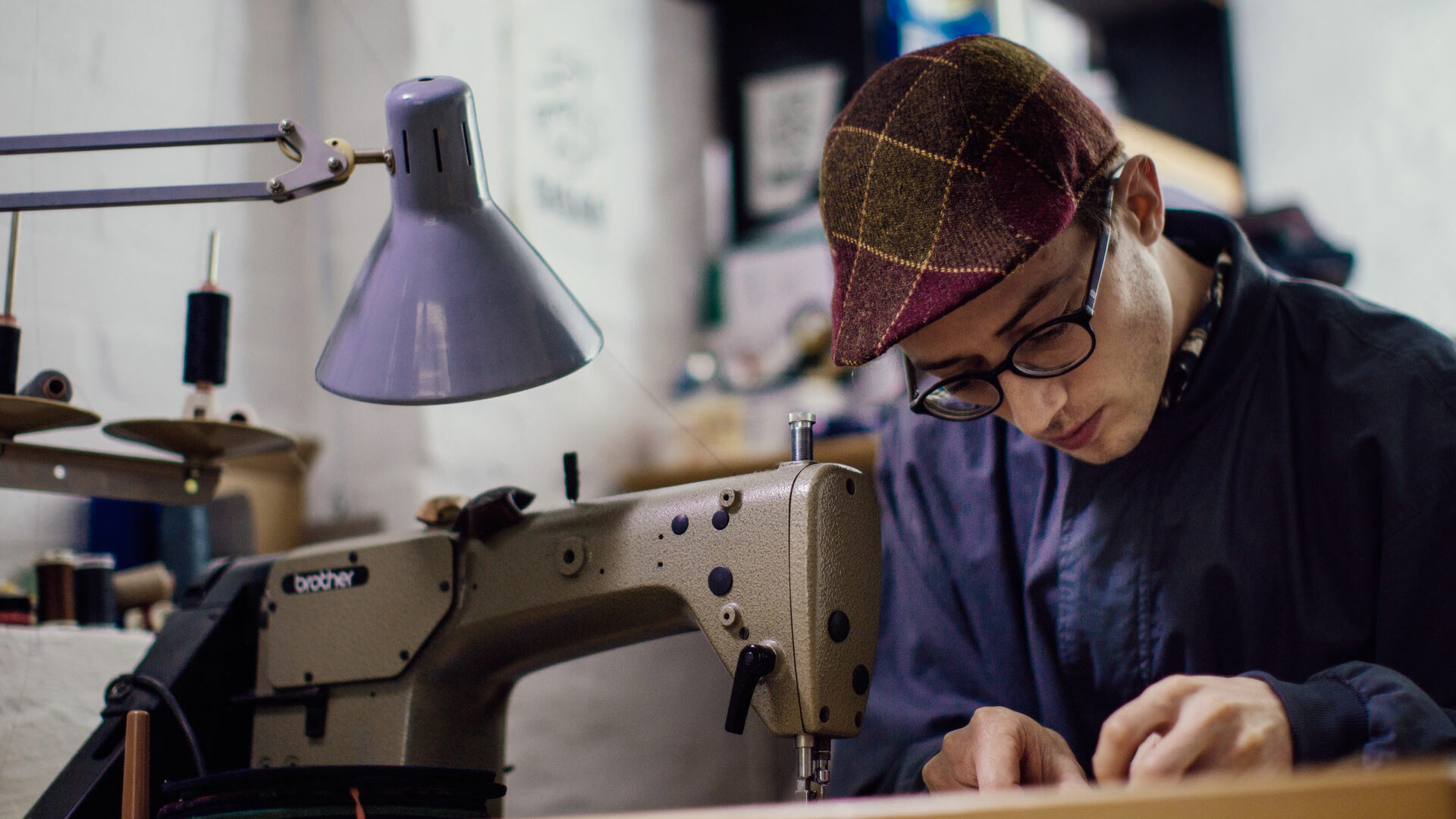 The capmaker Silas Gärtner at his sewing machine